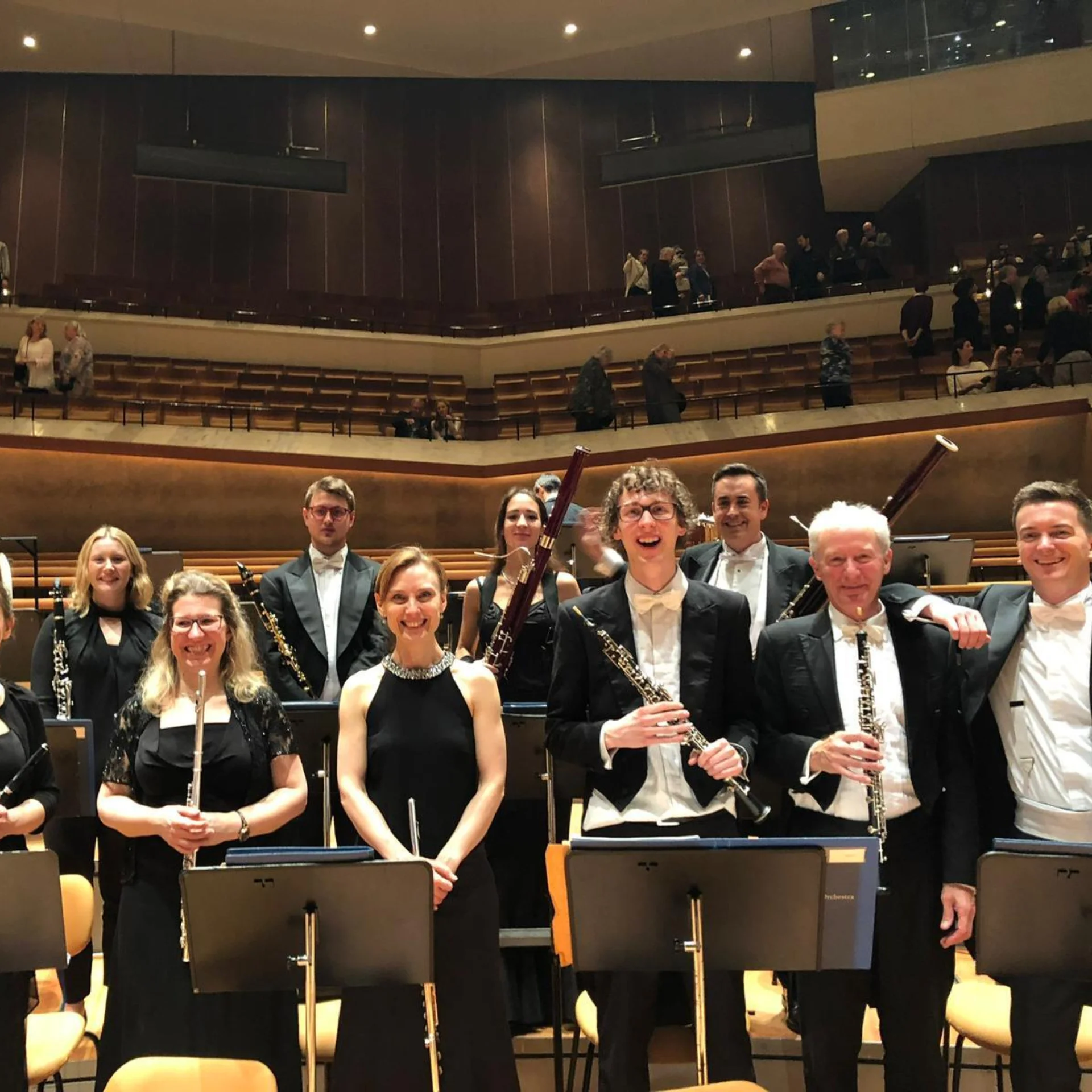 The wind section posing for the camera after a concert