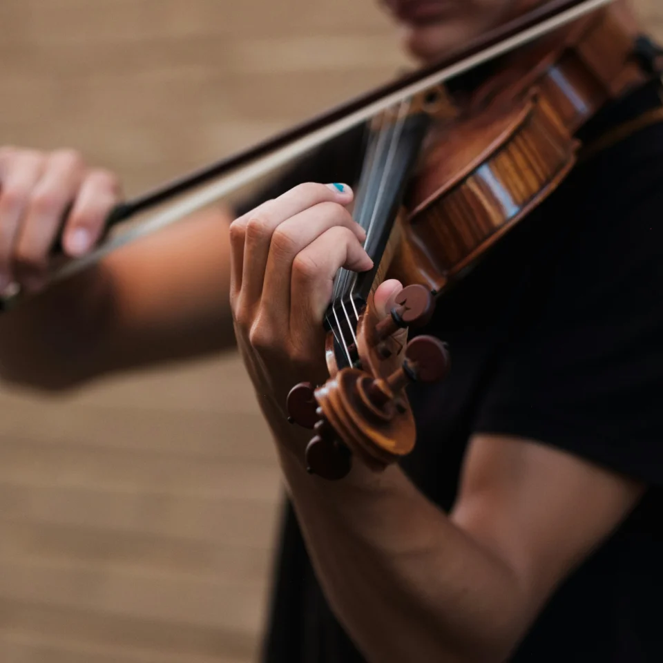 Close-up of a violin player holding and playing a violin