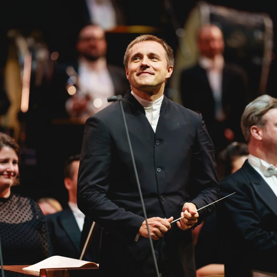 Vasily Petrenko smiling as he and the Orchestra receive applause at the Royal Albert Hall