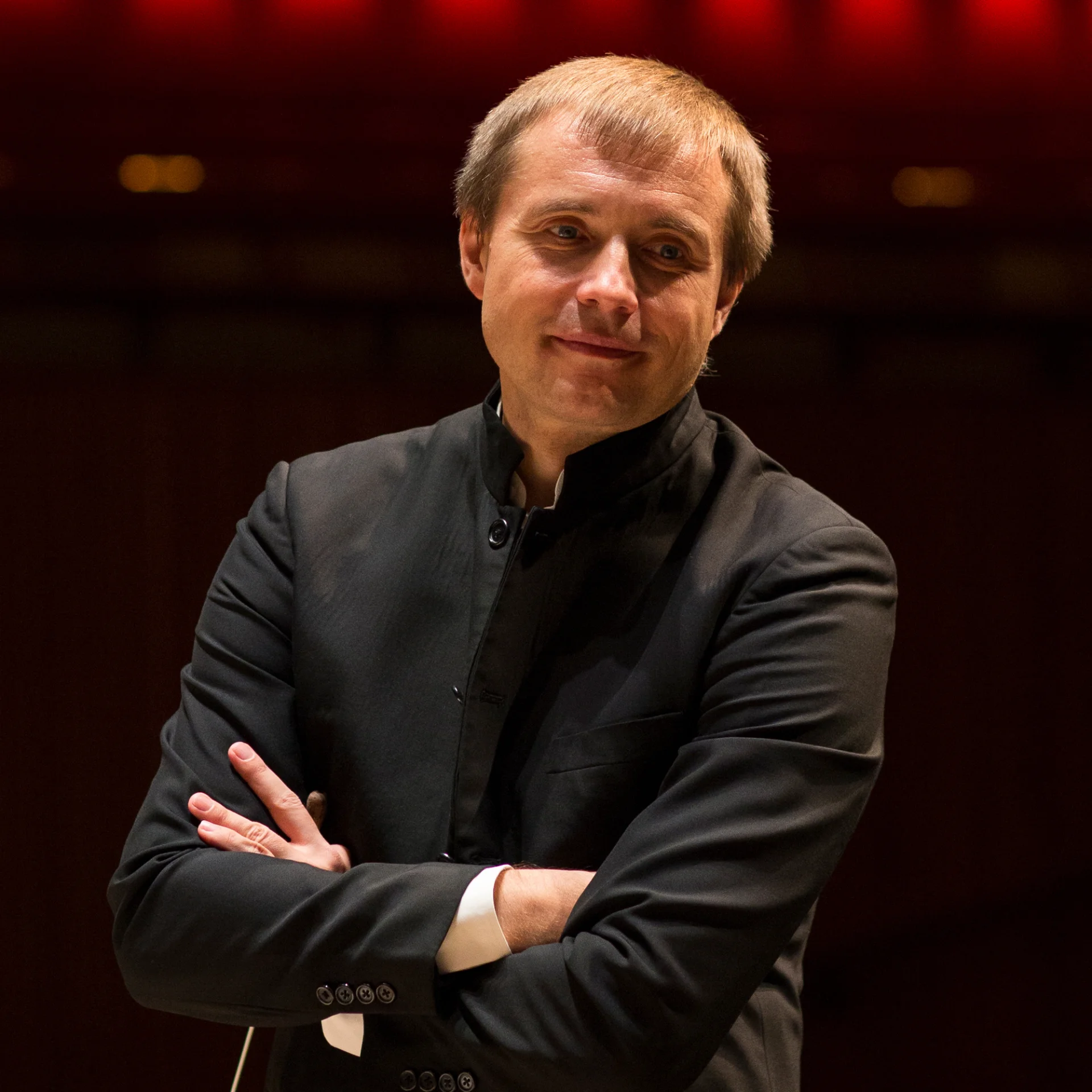Vasily Petrenko folding his arms and smiling in a rehearsal
