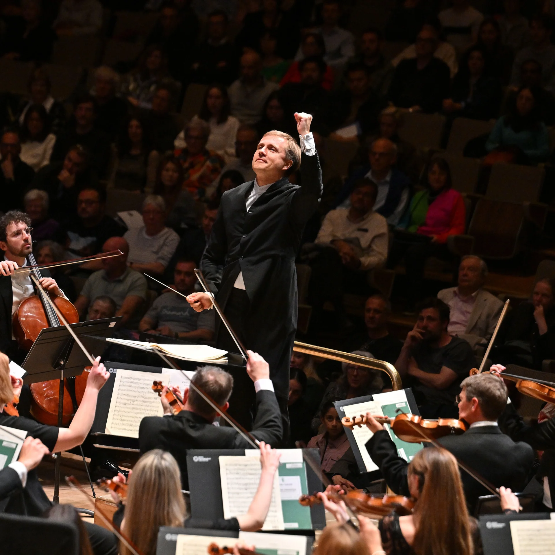 Vasily Petrenko conducting with his head raised and his left hand in a fist
