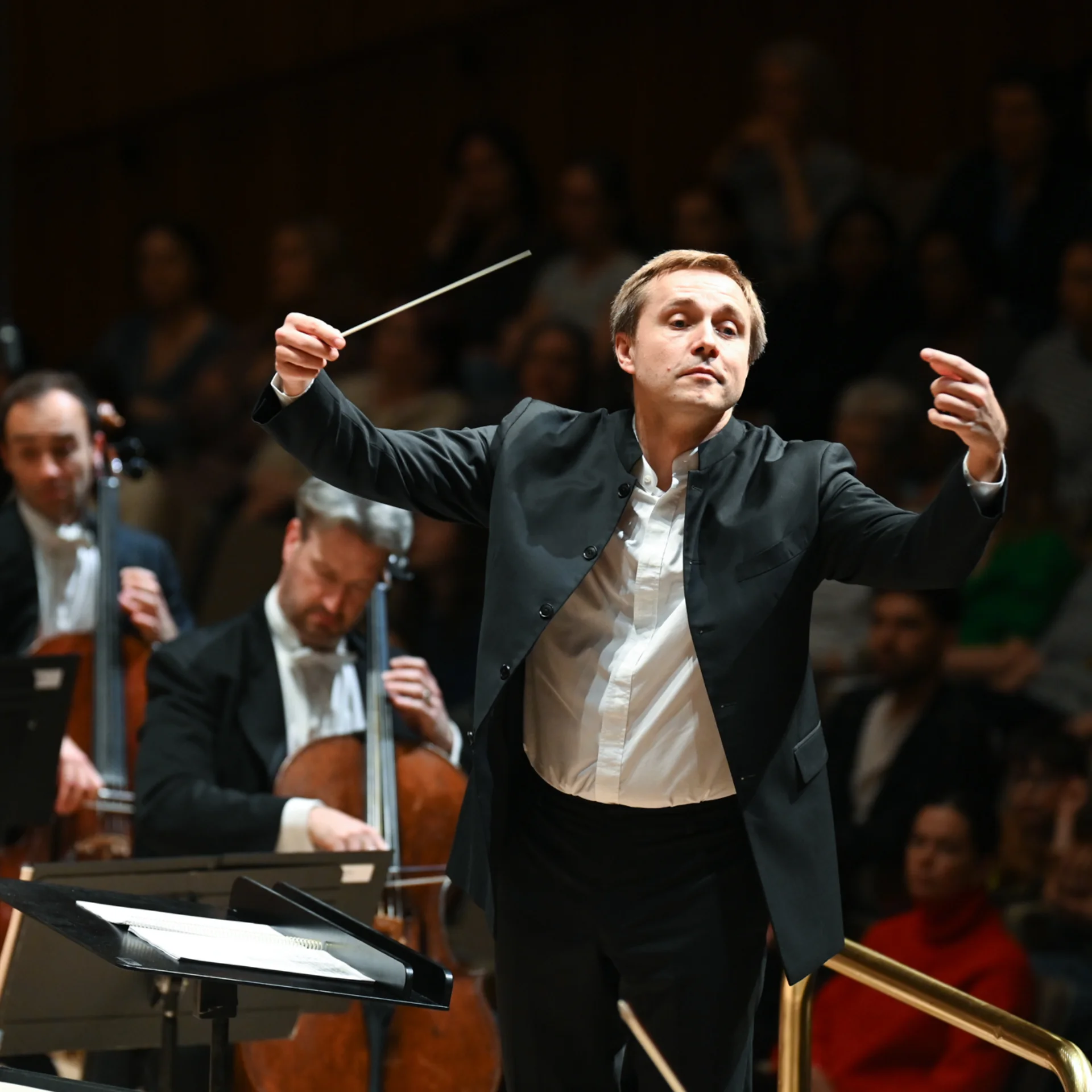 Vasily Petrenko is shown conducting with his arms up on stage the Royal Festival Hall