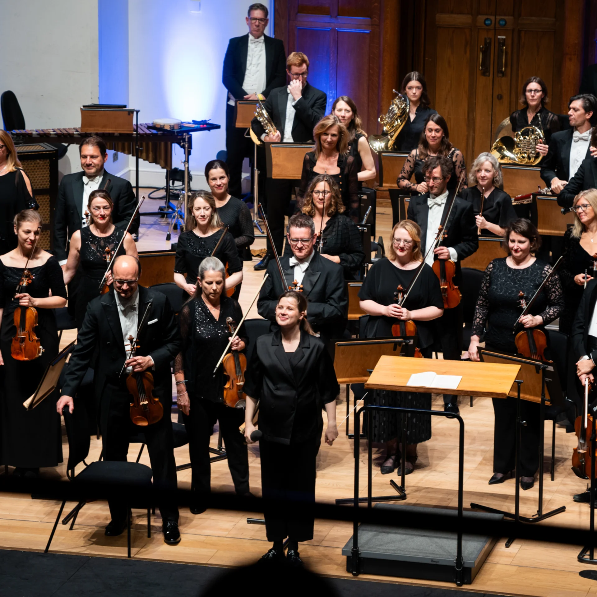 Orchestra standing on stage at Cadogan Hall