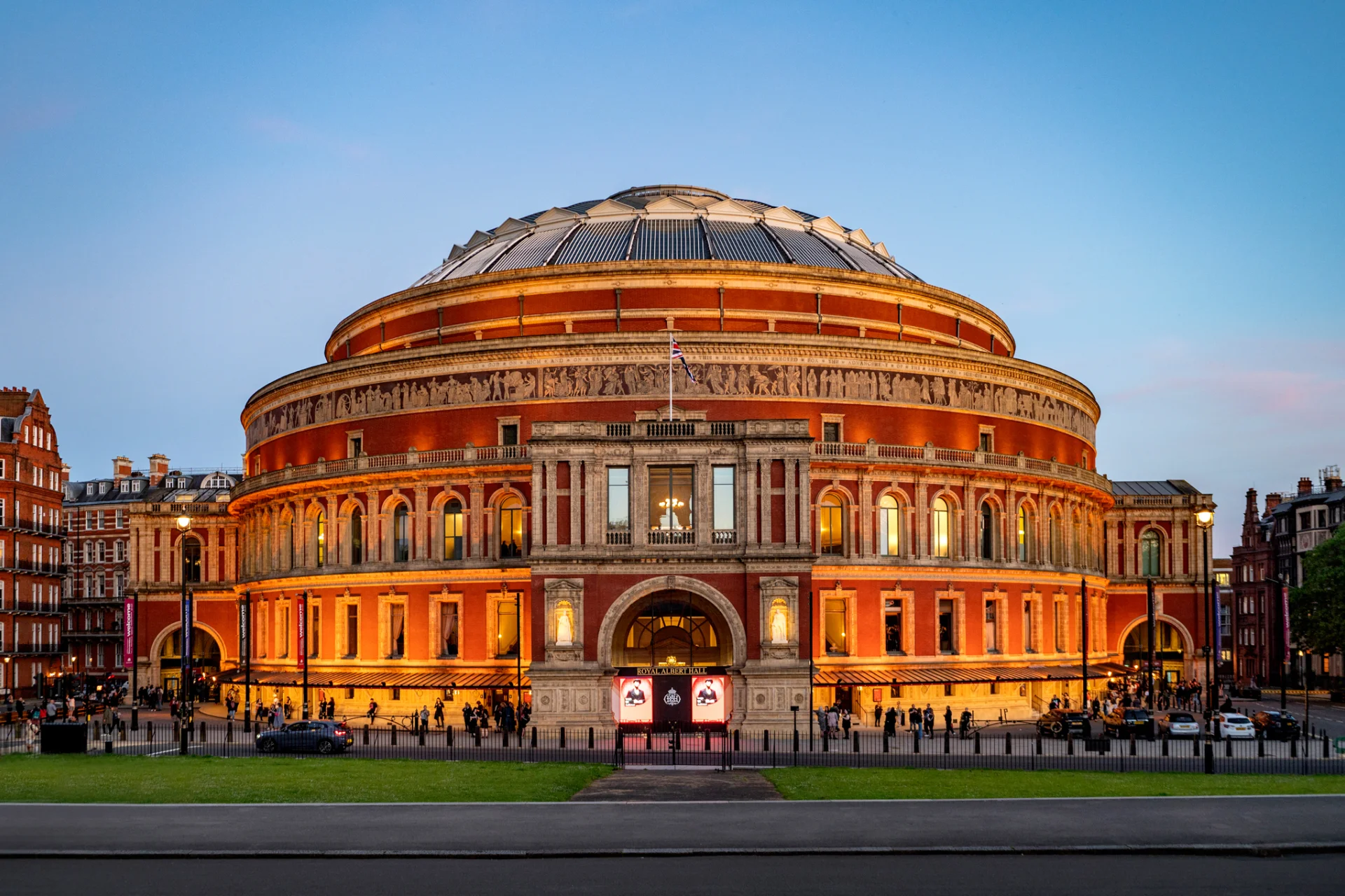 The Royal Abert Hall at dusk, glowing with its lights on