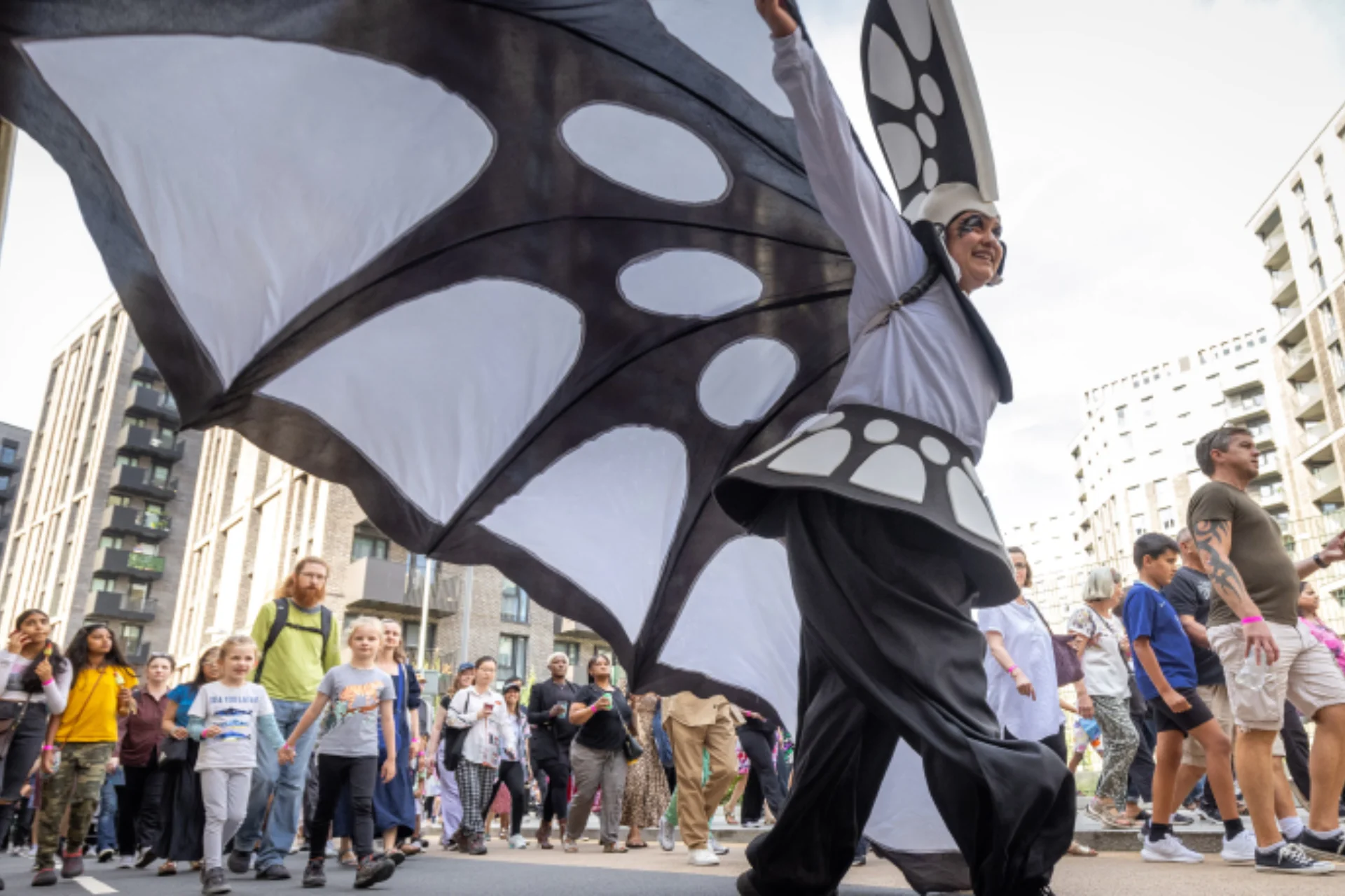A person in a blcak and white butterfly carnival costume in Wembley Park